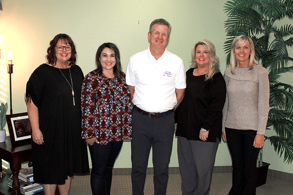 Dr. Tanner and staff standing in their office